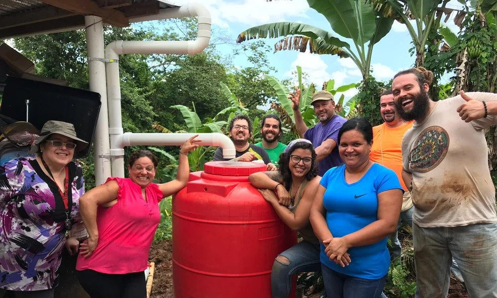 Amber Cares volunteers installing a water tank