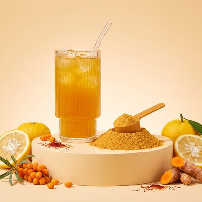 A glass of Amber Golden Superfoods with a scoop of golden powder, yuzu, sea buckthorn and turmeric